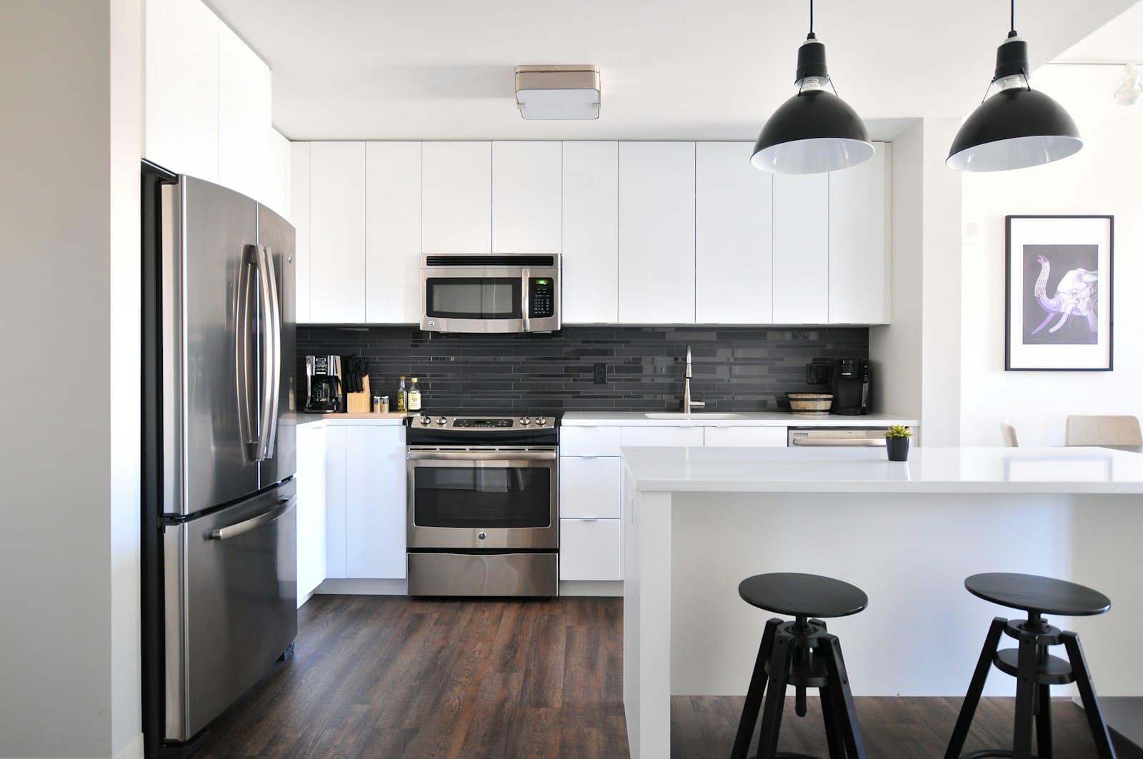 Clean modern kitchen with white cabinets and a breakfast counter